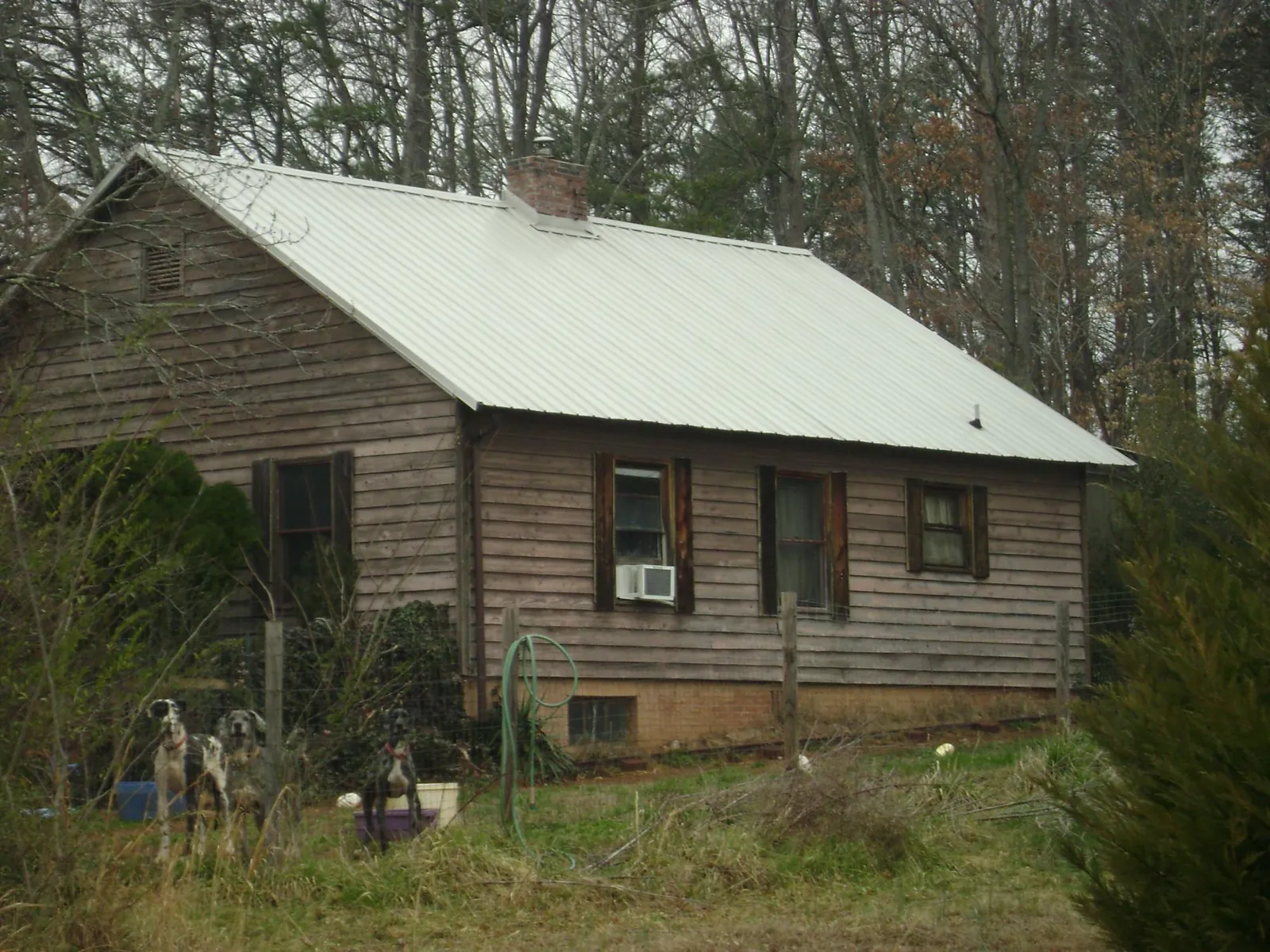 White metal roof on an old wood sided farmhouse, from a Metal Roof Installation job in Gallitzin